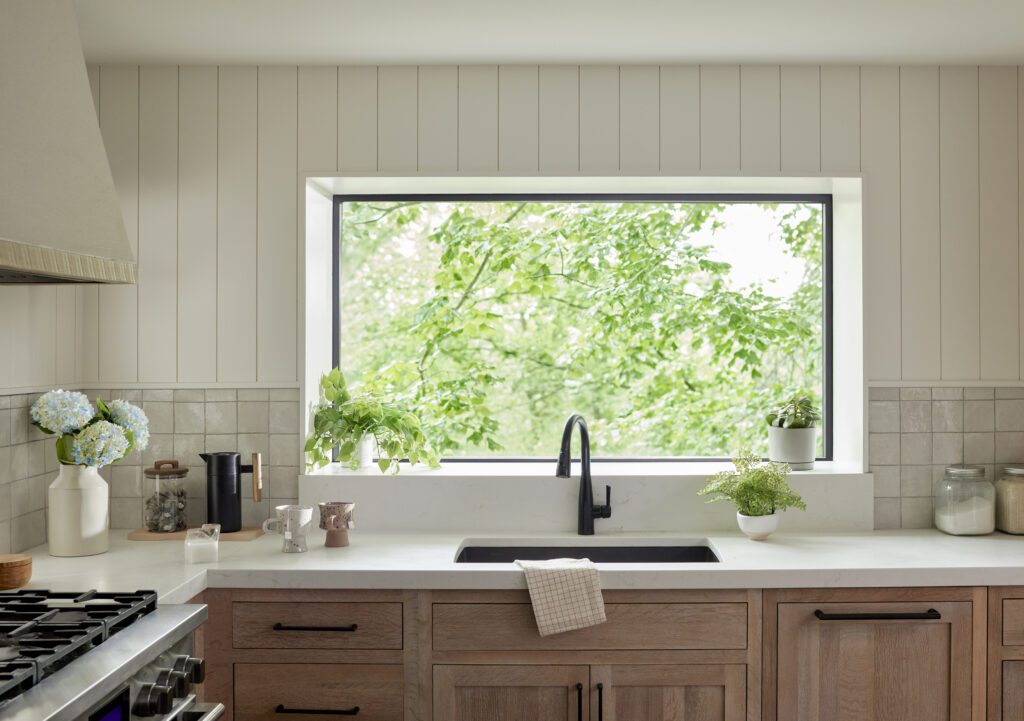 Black Pella Impervia fiberglass fixed garden window over the kitchen sink.