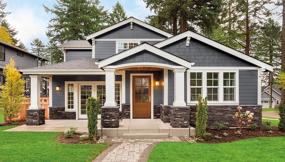 grey home with cedar shake siding and fiberglass entry door