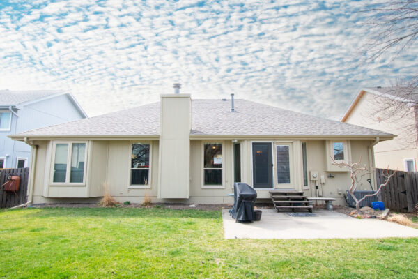 Vinyl window replacement on tan house