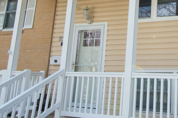 White fiberglass entry door with storm door