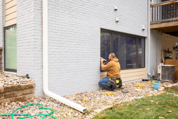 Pella expert installer working on basement window