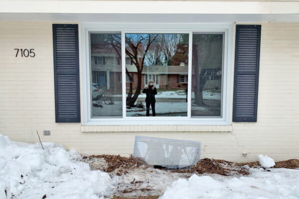 White Pella Impervia Sliding window at front of house